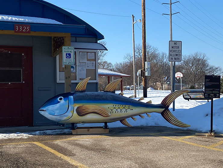 A large fish near the entrance to a building.