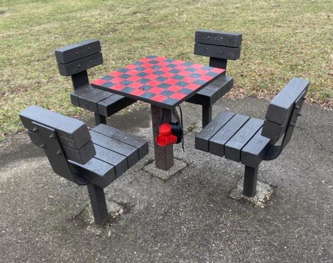 checkers table with four wooden seats