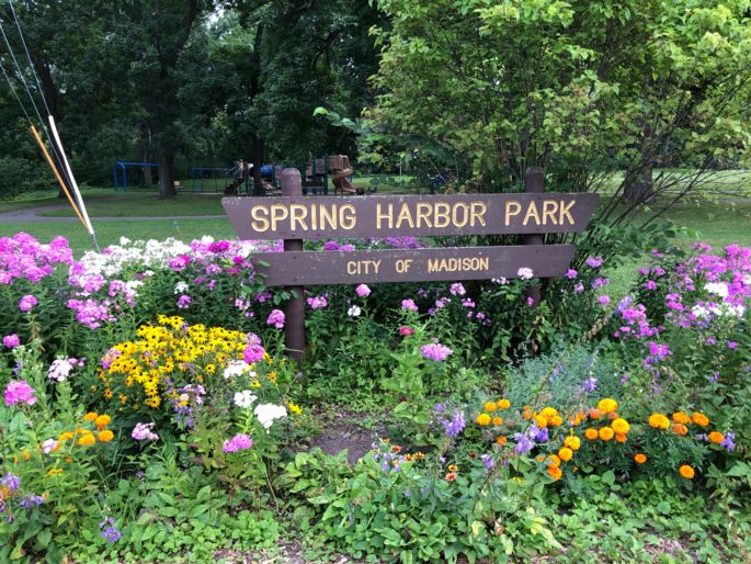 spring harbor park sign with many colorful flowers