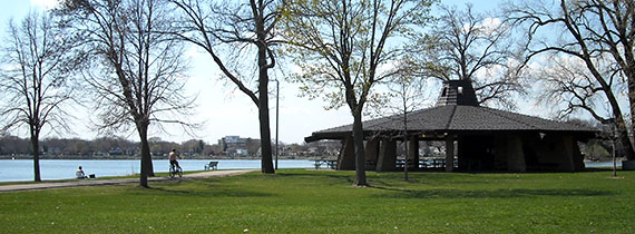 Park with grassy area and shelter overlooking the lake. 