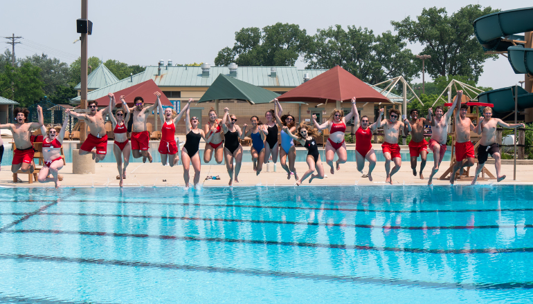 lifeguards jumping into goodman pool