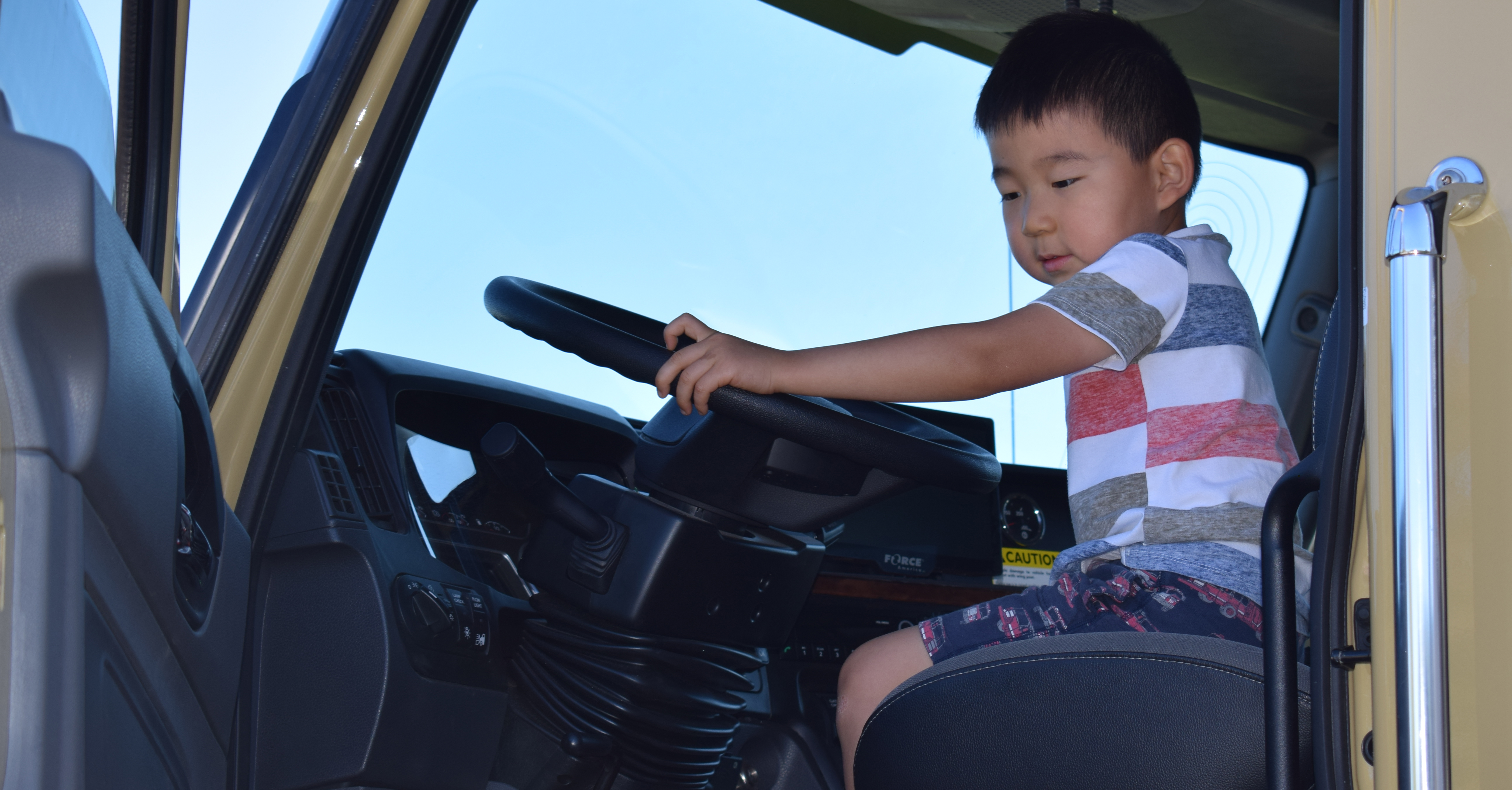 child sitting inside dump truck "driving"